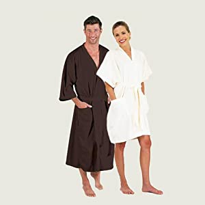 Man and woman leaning together wearing robes smiling at the camera