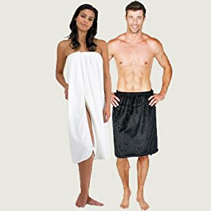 Man and woman standing side by side, smiling at the camera, wearing towels